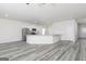 Open-concept kitchen boasts white cabinets, gray countertops, and modern stainless steel appliances at 451 Prescott Way, Villa Rica, GA 30180