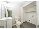 Bathroom featuring a white vanity and toilet plus a laundry area at 3913 Landgraf Cv, Decatur, GA 30034