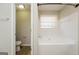 Bright bathroom with white tub, shower, and modern fixtures at 3913 Landgraf Cv, Decatur, GA 30034
