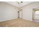 Bedroom with neutral carpet, ceiling fan, and access to an ensuite bathroom at 3913 Landgraf Cv, Decatur, GA 30034