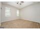 Cozy bedroom featuring plush carpet, ceiling fan, and bright natural light at 3913 Landgraf Cv, Decatur, GA 30034