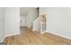 Open entryway with wood floors, staircase, and neutral wall colors at 3913 Landgraf Cv, Decatur, GA 30034