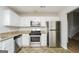 Updated kitchen with stainless steel appliances and granite countertops at 3913 Landgraf Cv, Decatur, GA 30034