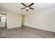 This living room features light walls, gray flooring, and a ceiling fan at 3913 Landgraf Cv, Decatur, GA 30034