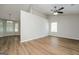 Bright living room with wood floors, ceiling fan, and large windows at 3913 Landgraf Cv, Decatur, GA 30034