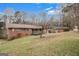 Spacious backyard featuring a single-story brick home with rear access ramp and traditional design at 2807 Knollview Dr, Decatur, GA 30034