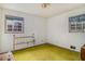 Small bedroom featuring a classic gold bed frame and yellow carpet at 2807 Knollview Dr, Decatur, GA 30034