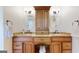 Bathroom with granite counters, dual sinks, wooden cabinets and decorative light fixtures at 2897 Macaw Nw St, Atlanta, GA 30318