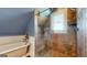 Elegant bathroom boasts a tiled shower with glass doors and a classic soaking tub at 2897 Macaw Nw St, Atlanta, GA 30318