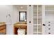 Dressing area with vanity, granite counters, makeup mirror and door leading to custom shelving at 2897 Macaw Nw St, Atlanta, GA 30318