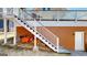 Staircase leading to the upper-level deck, surrounded by manicured landscaping at 2897 Macaw Nw St, Atlanta, GA 30318