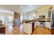 Bright kitchen with stainless appliances, tiled floors and exposed brick column and fireplace at 2897 Macaw Nw St, Atlanta, GA 30318
