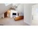 Living room with exposed brick, leather sofa, tv, carpeted floors, skylights and an adjacent bathroom at 2897 Macaw Nw St, Atlanta, GA 30318