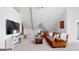 Bright, spacious living room featuring vaulted ceilings, plush seating, and a large TV at 2897 Macaw Nw St, Atlanta, GA 30318