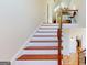 Staircase features wood steps, white risers, dark railing, and an open balcony above at 2897 Macaw Nw St, Atlanta, GA 30318