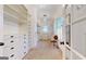 Large walk-in closet with white shelving, drawers, carpet, and a window to provide natural light at 2897 Macaw Nw St, Atlanta, GA 30318