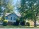 Charming two-story home with a well-manicured lawn and mature trees at 6012 Happy Trls Ct, Lithonia, GA 30058