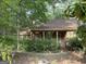Charming home featuring a covered front porch with classic columns and verdant landscaping, creating a serene curb appeal at 106 Amblewood Ct, Peachtree City, GA 30269
