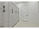 Abundant storage with gray cabinets and black hardware, complemented by light tile flooring and fresh white walls at 1240 Hayes Sq, Peachtree City, GA 30269