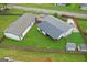 Aerial view of a well-maintained property with a spacious yard and multiple buildings at 80 David Rd, Hampton, GA 30228