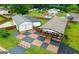 Aerial view of the property showing a detached garage, pool, and checkerboard driveway at 80 David Rd, Hampton, GA 30228