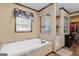 Bright bathroom featuring a soaking tub, shower, and tile accents at 80 David Rd, Hampton, GA 30228