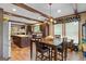 Open-concept dining area featuring wood beams, and a kitchen island with counter seating at 80 David Rd, Hampton, GA 30228