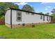 Exterior view of a white home with black trim and green lawn at 80 David Rd, Hampton, GA 30228