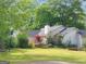 Spacious backyard with mature trees, a wooden deck, and lush green grass at 125 Burnside St, Jonesboro, GA 30236