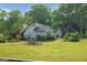 Well-maintained exterior with a lush lawn, mature trees, and a classic architectural style at 125 Burnside St, Jonesboro, GA 30236