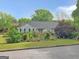 Charming single-story home featuring a well-manicured lawn and inviting front deck at 125 Burnside St, Jonesboro, GA 30236