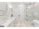 Modern bathroom with a double vanity, heated tile floor, walk-in shower, and separate soaking tub at 915 Laurel Brooke Ave, Peachtree City, GA 30269