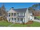 Stunning two-story home boasts a welcoming porch, white columns, and professionally landscaped front yard at 915 Laurel Brooke Ave, Peachtree City, GA 30269