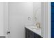Elegant powder room featuring a stylish vanity, marble countertop and modern fixtures in a compact space at 915 Laurel Brooke Ave, Peachtree City, GA 30269