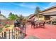 Backyard patio boasts a grill, outdoor furniture, a hammock, and a privacy fence with colorful flowers at 3259 Baylor Cir, Mcdonough, GA 30253