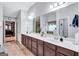 Bathroom features a double vanity with white countertops and modern fixtures and large vanity mirrors at 3259 Baylor Cir, Mcdonough, GA 30253