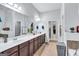 Bathroom boasts a double vanity with a large mirror, as well as tiled floors and modern light fixtures at 3259 Baylor Cir, Mcdonough, GA 30253