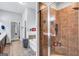 Bathroom featuring tile floors, double vanity, walk-in shower, and a soaking tub, as well as storage at 3259 Baylor Cir, Mcdonough, GA 30253