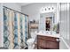 Cozy bathroom featuring a shower with a curtain and a vanity with storage space at 3259 Baylor Cir, Mcdonough, GA 30253