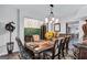 Dining room features a large table set for dining, complemented by an elegant chandelier at 3259 Baylor Cir, Mcdonough, GA 30253