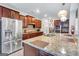 Gourmet kitchen featuring stainless steel appliances, granite countertops, and dark wood cabinets at 3259 Baylor Cir, Mcdonough, GA 30253