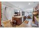 Open concept kitchen features a large island with seating, stainless steel appliances, and wood flooring at 3259 Baylor Cir, Mcdonough, GA 30253