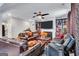 Spacious living room featuring plush seating, a fireplace with mounted TV, and ample natural light at 3259 Baylor Cir, Mcdonough, GA 30253