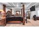 Spacious main bedroom boasts a tray ceiling, four-poster bed, dresser, and decorative mirror at 3259 Baylor Cir, Mcdonough, GA 30253