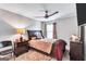 Inviting primary bedroom features a ceiling fan, window with blinds, and dark wood furniture at 3259 Baylor Cir, Mcdonough, GA 30253