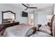 Primary bedroom boasts a ceiling fan, TV, and dark wood furniture in a relaxing space at 3259 Baylor Cir, Mcdonough, GA 30253