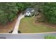 Charming traditional home with a spacious lawn, long driveway, and lush surrounding trees at 416 Line Creek Cir, Sharpsburg, GA 30277