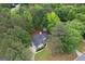 Aerial view of a single-Gathering home surrounded by lush greenery, mature trees and well manicured yard at 416 Line Creek Cir, Sharpsburg, GA 30277