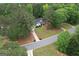 Aerial view of a home with a long driveway, green lawn, and an abundance of trees at 416 Line Creek Cir, Sharpsburg, GA 30277