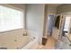 Bathroom featuring a garden tub and view of the granite counter top vanity at 416 Line Creek Cir, Sharpsburg, GA 30277
